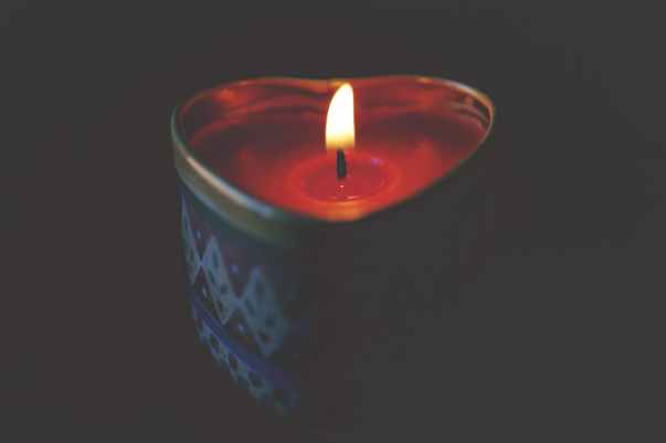 close up of tea light candle against black background